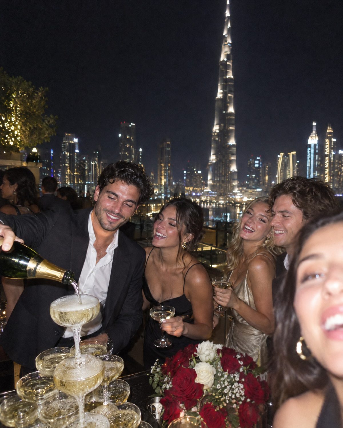 Champagne tower at a Downtown rooftop party with the Burj Khalifa behind